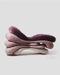 three different types of pillows stacked on top of each other in the shape of an object