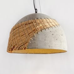 a light that has some kind of thing hanging from it's side and is made out of concrete