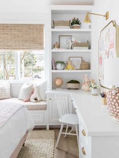 a bedroom with white furniture and shelves filled with bookshelves, pillows, and other items