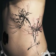 a woman's stomach with an artistic tattoo design on her lower back and side