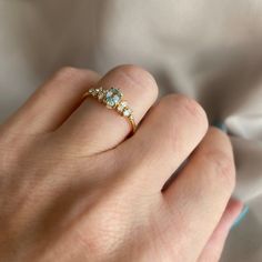 a woman's hand with a diamond ring on it