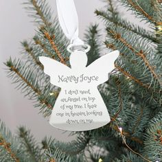 an angel ornament hanging from a christmas tree with the words nammy joyce on it