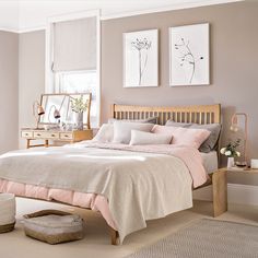 a bed room with a neatly made bed and two pictures on the wall above it