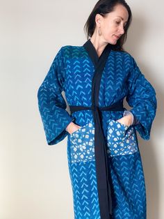 Regal warm jacket kimono in beautiful indigo and block print... perfect for fall and winter. Unisex one size with pockets! Warm and soft and great for cozy winter days and nights. Wear as a robe, coat, jacket or kimono! Detached belt included.  Reversible. Patchwork. Gorgeous indigo kantha. Handmade. Up-cycled and Repurposed. Made from kantha hand stitched quilt.  Unisex. Looks great on all!  Measurements: Length of Kimono = 51 inches / Chest = 46 inches / Sleeve Length = 22 inches Blue Cotton Kimono For Loungewear, Blue Long-sleeved Cotton Kimono, Blue Kimono Sleeve Robe For Home, Blue Cotton Long Sleeve Kimono, Long Sleeve Blue Kimono For Loungewear, Blue Long Sleeve Kimono For Loungewear, Blue Long Sleeve Cotton Kimono, Blue Robe With Kimono Sleeves For Home, Bohemian Indigo Long Sleeve Kimono