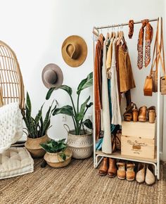 an organized closet with shoes, hats and other items on shelves next to plants in baskets