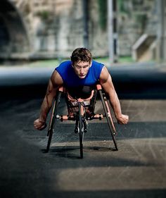 a man in a wheelchair is doing push ups