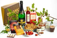 an assortment of food and drinks on a white table with a box in the background