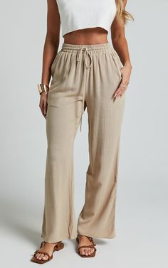 Get ready to elevate your pants game with our Kala Pants in Sand! These mid-waisted, relaxed elastic waist pants are perfect for adding a touch of casual chic to any outfit. Made from soft and breathable cotton, these full-length pants will keep you comfortable all day long. Whether you're going for a laid-back look or dressing up for a party, the neutral color of these pants makes them incredibly versatile. Embrace your individuality and showcase your style with our empowering Kala Pants! Produ Relaxed Straight Leg Bottoms With Pull-on Style, Relaxed Straight Leg Pull-on Bottoms, Relaxed Pull-on Straight Leg Bottoms, Effortless Relaxed Fit High-waisted Pants, Relaxed Straight Leg Bottoms With Elastic Waistband, Versatile Summer Sweatpants With Elastic Waistband, Solid Straight Leg Harem Pants For Loungewear, Effortless High-waisted Loungewear Pants, Relaxed Fit Pants For Summer Lounging