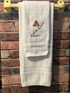 a towel hanging on a brick wall with the words we love shawve printed on it