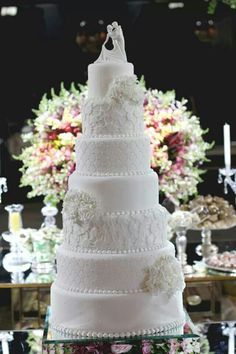 a white wedding cake sitting on top of a table