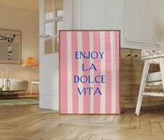 a pink and white striped poster with the words enjoy la dolce vita in blue