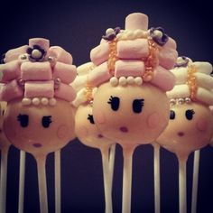 some kind of cake pops that are decorated with pink and white frosting on them