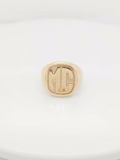 "Here we have a beautiful 14k yellow gold mc initial ring. Weigth: 16.9g. Width: 0.60\". In excellent condition. The perfect gift for your loved one. Comes with a free gift box." Modern Hallmarked Initial Ring For Formal Occasions, Luxury 14k Gold Monogram Rings, Luxury Yellow Gold Initial Ring For Formal Occasions, Timeless Monogram Initial Ring For Formal Occasions, Timeless Formal Monogram Initial Ring, Formal Timeless Monogram Initial Ring, Classic Gold Initial Ring With Hallmarks, Classic 14k Gold Monogram Rings, Luxury Yellow Gold Initial Ring Hallmarked