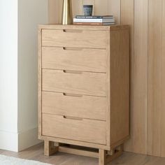 a wooden chest of drawers in a room