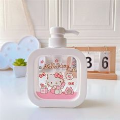 a hello kitty soap dispenser sitting on top of a counter