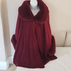 Beautiful Burgundy Faux Fur Jacket That Will Add Elegance And Warmth To Your Wardrobe Fitted Long Sleeve Winter Cape, Fitted Long Sleeve Cape For Winter, Fall Cape Outerwear With Faux Fur Lining, Fall Cape With Faux Fur Lining, Red Cape For Fall Outerwear, Red Cape Outerwear For Fall, Cape Outerwear With Faux Fur Trim For Cold Weather, Elegant Red Fur Coat For Winter, Elegant Burgundy Winter Outerwear