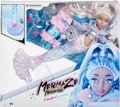 a barbie doll with blue hair and accessories in a box next to it's packaging