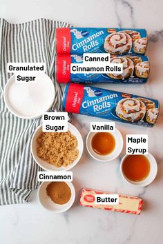 ingredients to make cinnamon rolls laid out on a marble counter top with striped napkins