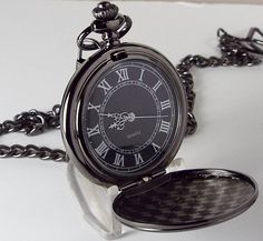 "The black finish on this beautiful pocket watch is perfect for those who don't care for the shiny, high polish finishes. The front cover is factory embossed with a textured design and features a crest shaped center. The back is also embossed with a beautiful ornate design. The bright white hands and numbers against the black dial make it really easy to see the time, and the center of the dial has a really unique, twister like design (shown in second picture). This pocket watch measures 1 7/8\" Vintage Black Pocket Watch Gift, Black Engraved Watch For Formal Occasions, Timeless Black Engraved Watch, Black Pocket Watch With Metal Dial As Gift, Black Timeless Pocket Watch For Formal Occasions, Script Monogram, Lettering Style, Id Bracelets, Watch Chain