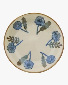 a blue and white plate with leaves on it