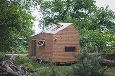 the tiny house is made out of wood and has a roof that looks like it could be built on wheels