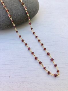 Garnet Necklace, Garnet Beaded Necklace, January Birthstone, Dainty Garnet Necklace, Red Choker Necklace, Simple Gold Necklace, Gift for her Beaded red garnet rosary style necklace wire wrapped in 14k gold filled or sterling silver. Rondelles are 3mm in size. Necklace closes with lobster clasp in the finish of your choice. About This Necklace: - Stone: Garnet - Birthstone Month: January - Garnet Properties: Friendship, Love and Guidance - Stone Size: 3mm - Necklace Length: Choice of 16 or 18 inc Faceted Beads Chain Necklace As Gift, Gift Chain Necklace With Faceted Beads, Gift Faceted Beads Chain Necklace, Red Beaded Chain Necklace Gift, Red Beaded Chain Necklace For Gift, Gift Red Beaded Chain Necklace, Red Garnet Gemstone Beaded Necklaces, Red Garnet Beaded Necklaces With Round Beads, Red Garnet Gemstone Beaded Necklace