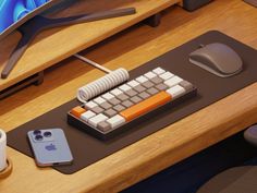 a computer keyboard sitting on top of a desk next to a mouse and cell phone