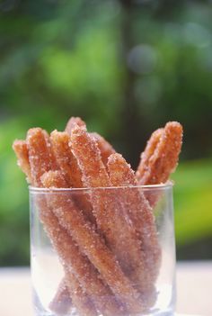 a glass filled with sugary treats sitting on top of a table