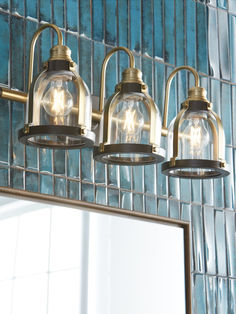 The image shows a bathroom vanity light fixture with a nautical theme.