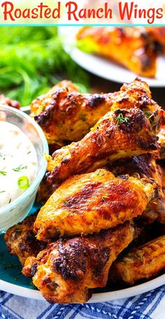 baked ranch wings on a blue plate with dip and parsley garnishes