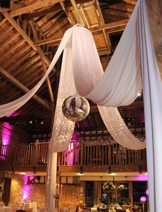 the inside of a building decorated with white draping