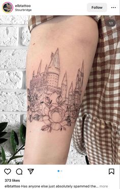 a woman's arm with a castle tattoo on it and flowers in the middle