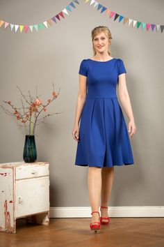 Gorgeous summer dress. An elegant Dress in fine Romance jersey in ink blue, with a knee-length swinging Skirt. The Width is created by four Inserted Wrinkles in the Front Part. The side pockets are casual and practical At the same time. The simple submarine neckline is particularly elegant. Valerie charms with a deep round back neckline that catches the eye. It's just so deep you can't see the underwear. With short puff sleeves. The dress is available in sizes 36-42. We also make the dress to yo Fit And Flare Elastane Formal Dress, Elegant Fit And Flare Elastane Dress, Elegant Fit And Flare Dresses, Formal Fit And Flare Elastane Dress, A-line Elastane Midi Dress For Party, Elegant Stretch Dresses With Pleated Skirt, Elastane A-line Cocktail Dress, Cocktail A-line Elastane Dress, Pleated Stretch Knee-length Midi Dress