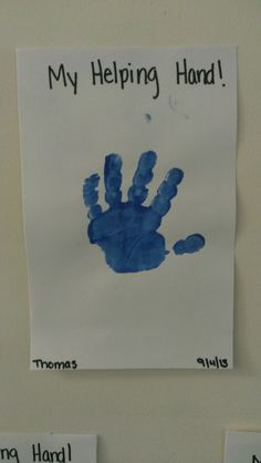 a handprint on a white wall that says, my helping hand