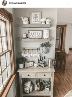 a coffee bar in the corner of a room next to a window with two shelves above it