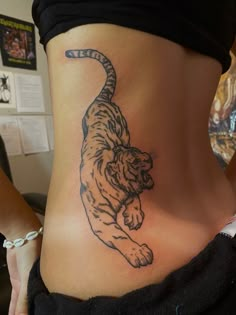 a woman with a tiger tattoo on her stomach