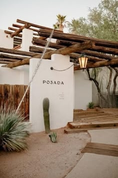 the entrance to posada in scottsdale, arizona with a cactus on the ground