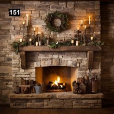 a fireplace with candles and wreaths on it