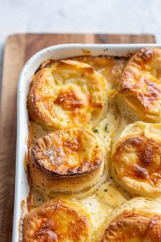 a casserole dish filled with baked potatoes