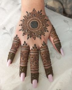 a woman's hand with hennap on it and an intricate design in the middle