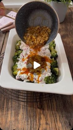 a bowl filled with food sitting on top of a wooden table