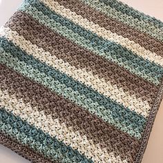 a crocheted blanket sitting on top of a table