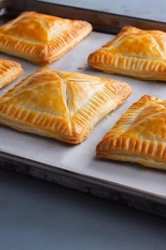 six pastries on a baking sheet ready to be baked