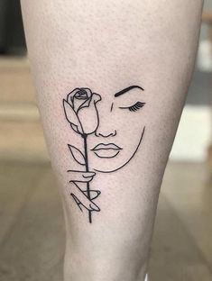 a woman's face with a rose tattoo on her leg and the word love written in black ink