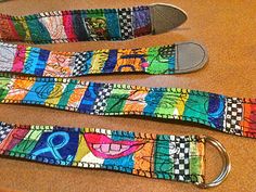 three colorful straps sitting on top of a wooden table