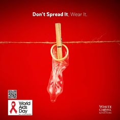 an ad for world aids day with a pair of scissors hanging on a rope and the words don't spread it wear it