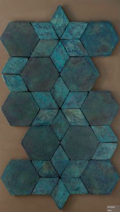 blue tiles are arranged in the shape of hexagonals on a brown surface