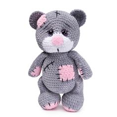 a crocheted gray teddy bear with pink spots