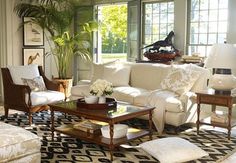 a living room filled with lots of white furniture