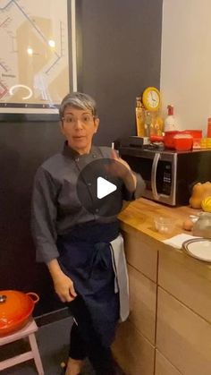 an older woman standing in front of a kitchen counter